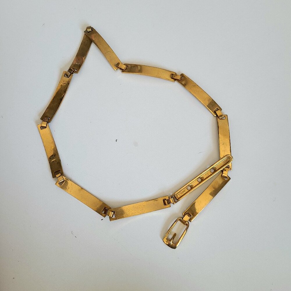 Gol tone metal belt.